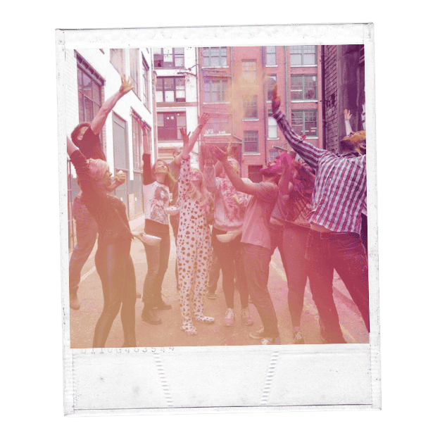 Image of group throwing colourful paint together